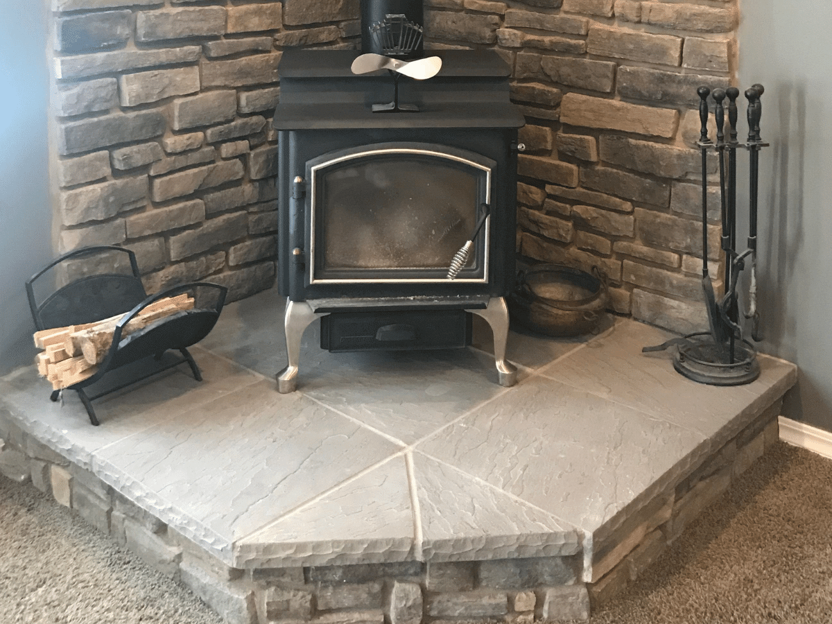 wood stove on raised stone hearth